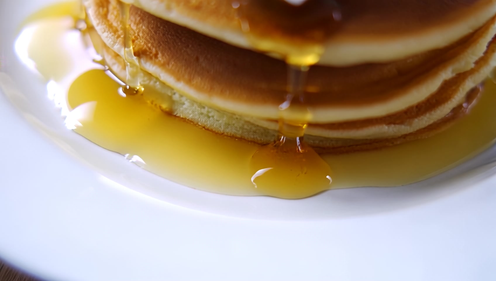 a white plate topped with pancakes  and whipped cream