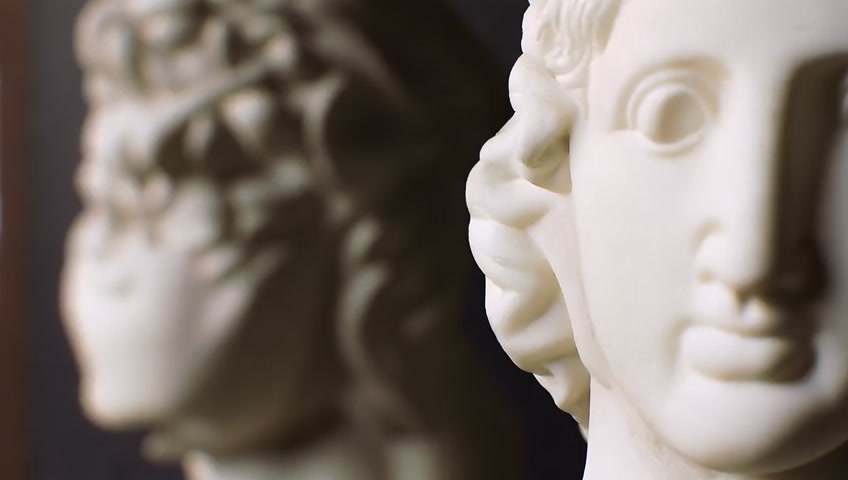 Focus changing between many famous roman sculptures busts made of marble. Closeup shots with focus pull.