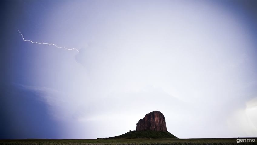 the monolith’s body surges with colossal billows of cumulus and cumulonimbus, their vast forms shifting like tectonic plates of vapor. They fold and unfold in slow, spiraling collapse, as if exhaling the breath of forgotten tempests. Deep within these undulating masses, lightning does not strike—it writhes in suspended arcs, spiraling through the mist in slow-motion flashes of silver fire, illuminating the storm’s vast, living heart.

And then—the arcus arrives.

Spiraling outward from the monolith’s edges, funnel roll arcus clouds twist in perfect, endless coils, their curling tendrils forming vast corridors of mist and shadow. They do not simply stretch; they move like the hands of unseen deities, spiraling toward the luminous river, as if drawn to its glow by some ancient, unspeakable yearning. They radiate a slow, thunderous hum, a vibration that can be felt in the bones of the air itself, a presence that suggests the storm is watching, waiting, listening