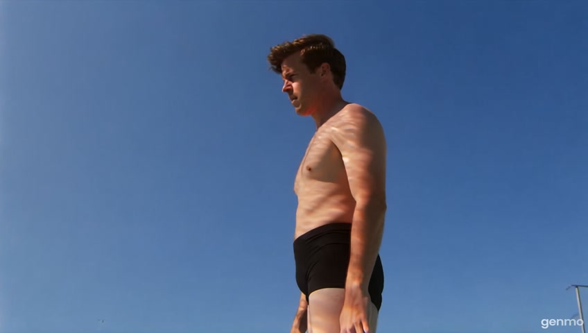 1980's Style TV Video. Medium-close up of A Man standing at the edge of a diving board. He is about to dive off. Similar feel to ABC Wide World of Sports. the man then dives, and the camera follows him all the way into the water and actually goes under water with him
