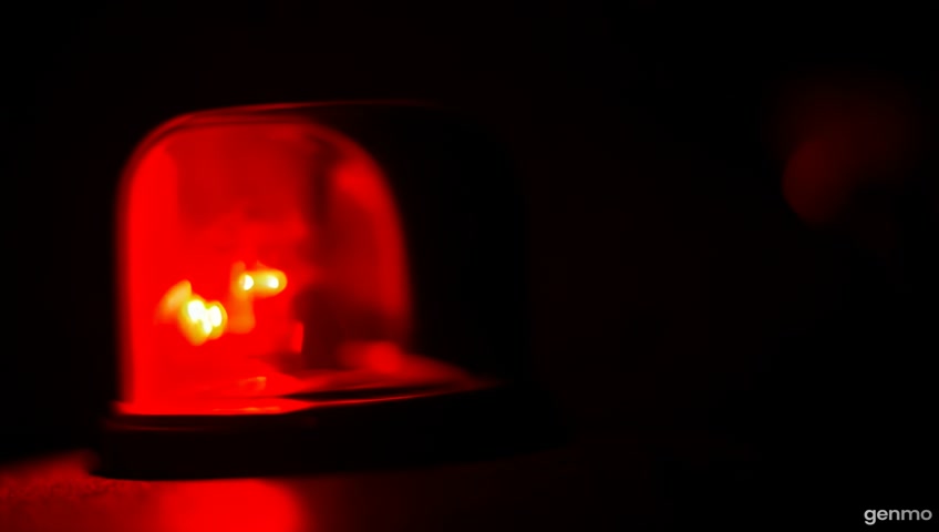 A red light that is blinking in the darkness