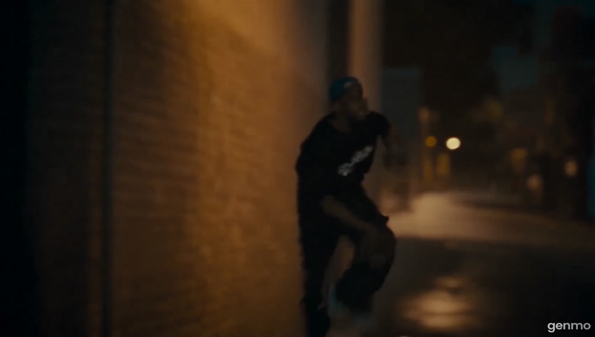 This video continues directly from the uploaded image. The miniature version of the man in the image — wearing a black Tupac shirt and blue cap — begins running forward quickly down a narrow alley lit by firelight and smoke. The camera follows as he turns sharply to the left and jumps over a parked car in slow motion. Sparks fly and the smoke shifts around him. The background moves with depth, lights flicker, and the ground reflects glowing fire. The character’s appearance, proportions, and style must stay exactly the same as in the image. Maintain miniature scale and realistic cinematic lighting. No changes to the character or scene style — just smooth, believable motion for a 10-second action clip