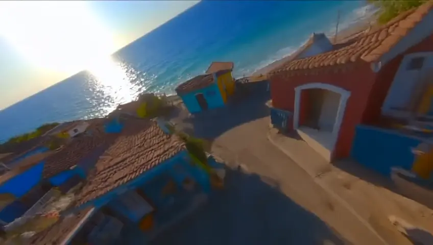 An FPV drone swoops through the colorful coral-lined street of an underwater neighborhood...