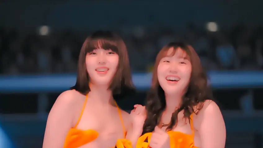 several gorgeous Korean women in Pumpkin themed bikinis are dancing in front of a crowd, they are Korean baseball cheerleaders, trendy Tik Tok dance, cheerful, sultry, energetic