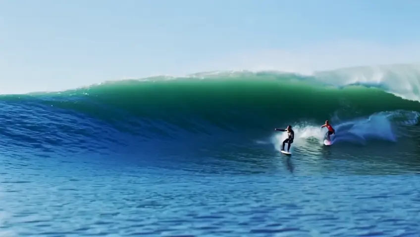 Chicks surfing a big wave