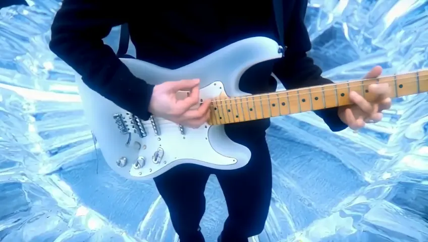 The guitarist plays a solo on an ice electric guitar in a circle of ice