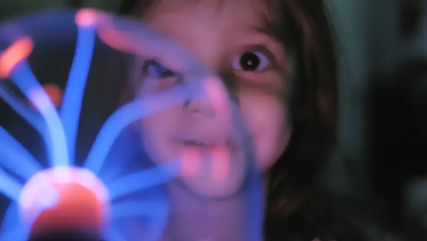 Girl holding a ball lightning ball, Looking at the camera and smiling