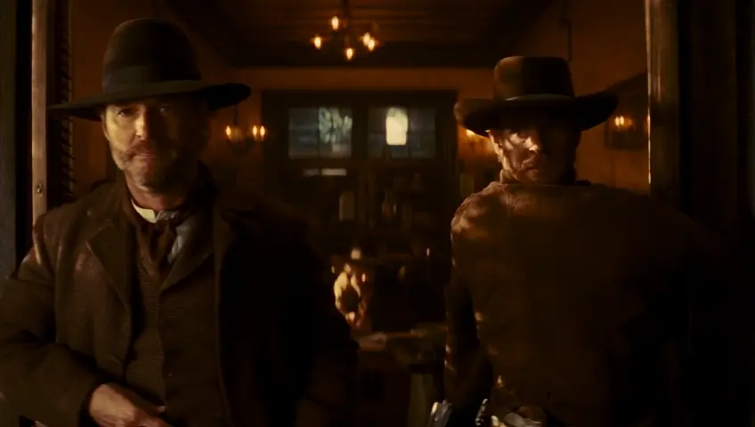 Close-up: Two calm and photogenic cowboys in their 30s, a man resembling singer Thomas Anders and a woman resembling actress Sharon Stone, wearing brown clothes and hats, enter the saloon full-length, both wearing trousers, swinging open the hinged double short doors with horizontal blinds. Cozy, beautiful, dimly lit late 19th century Western style cowboy saloon, atmospheric, cinematic