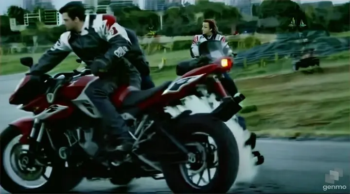 a man riding on the back of a red motorcycle