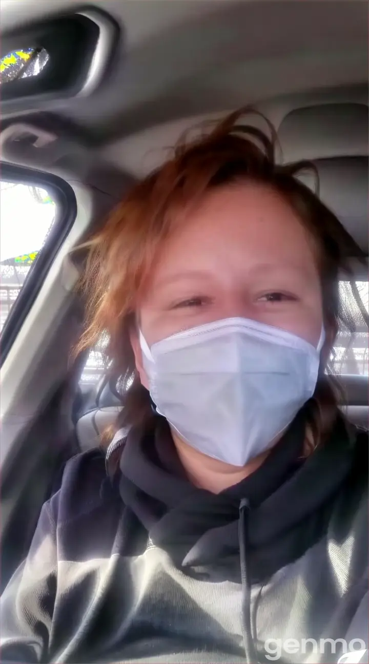 a woman in a car with a mask on