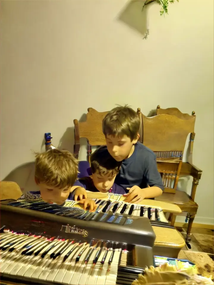 a boy and a boy sitting at a piano behind them are dinosaurs moving around