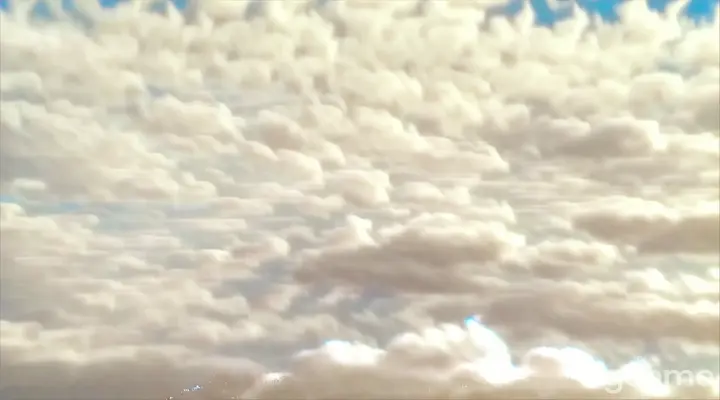 Fluffy clouds float swiftly across the sky 