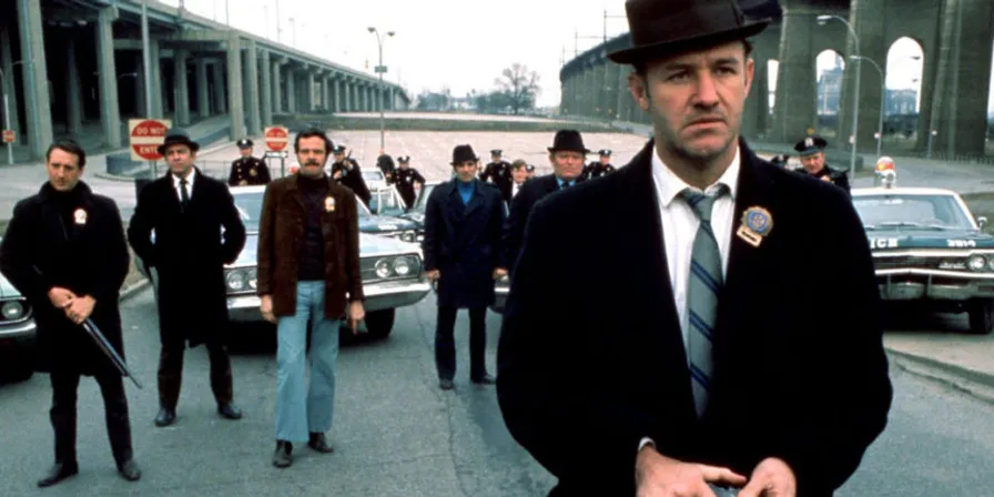 1974 style 35mm film of a man in a suit and tie walking down a brooklyn street