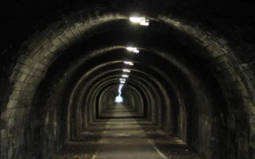 a long tunnel with a light at the end