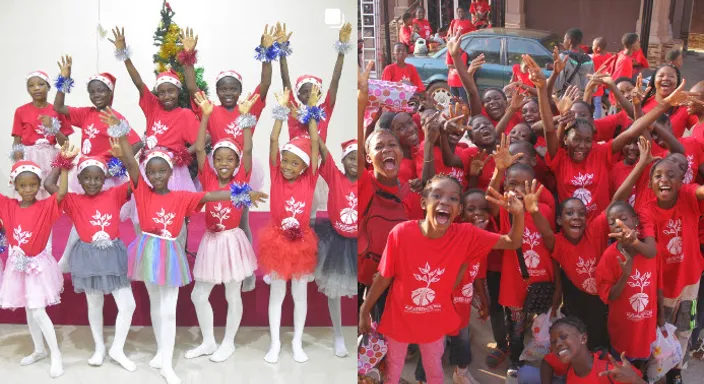 a group of children in red shirts posing for a picture