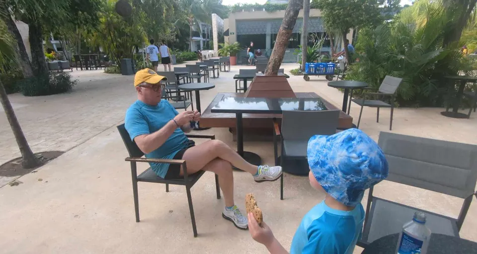 a man and a little boy sitting at a table