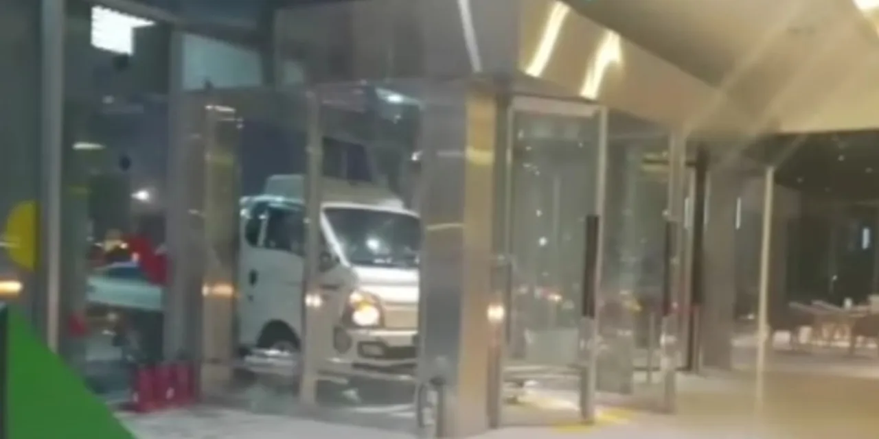 a silver truck parked in front of a building