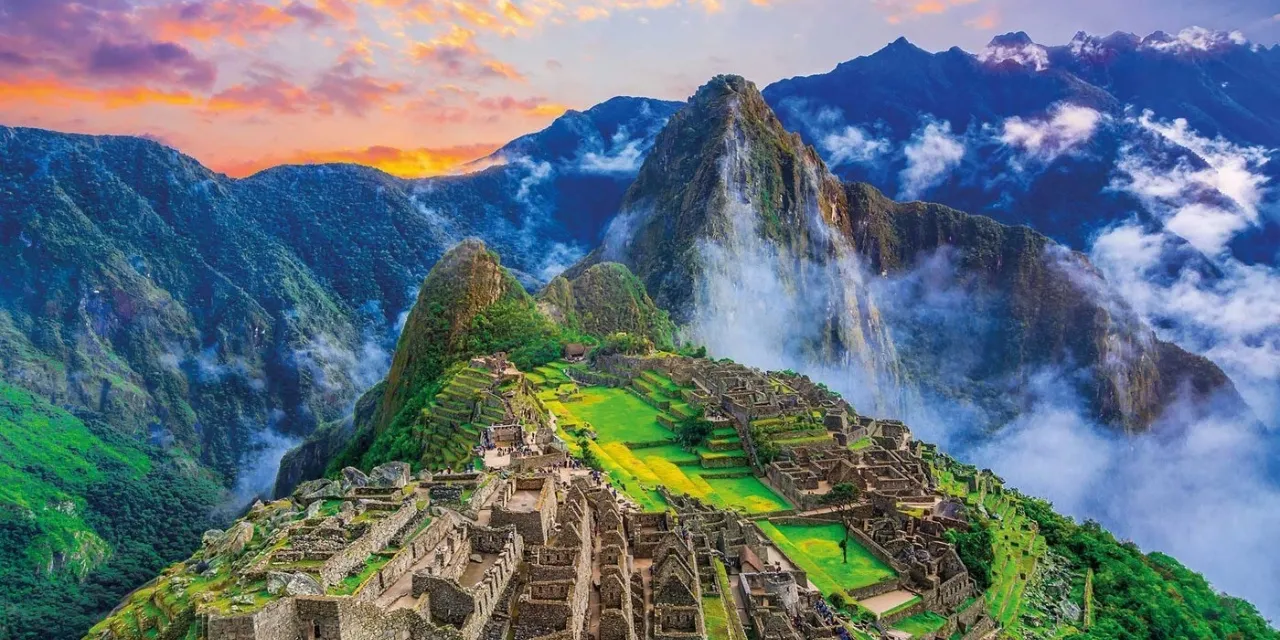 a picture of a mountain with a green field in front of it