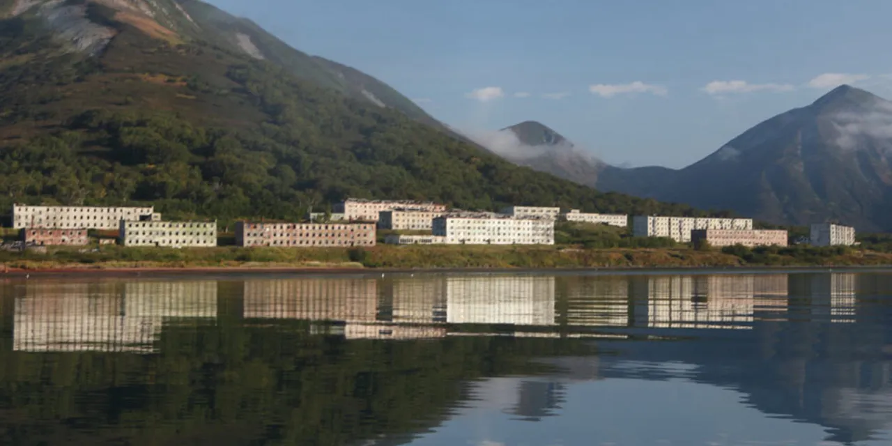 a large body of water with a mountain in the background