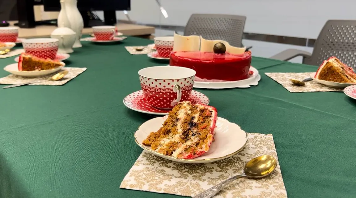 a table topped with plates of cake and cups