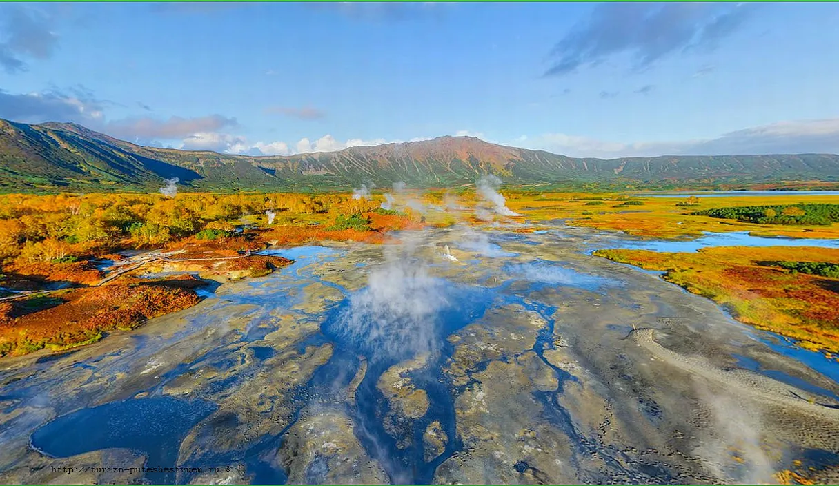 an aerial view of a body of water surrounded by mountains