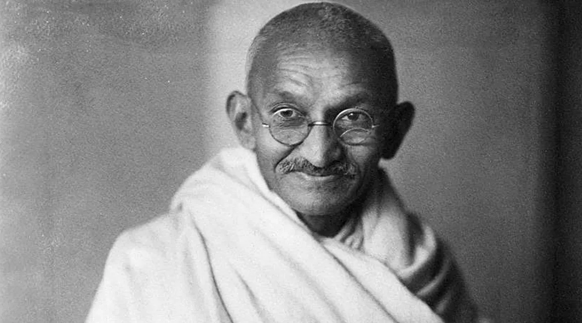 a black and white photo of a man with glasses Mahatma gandhi