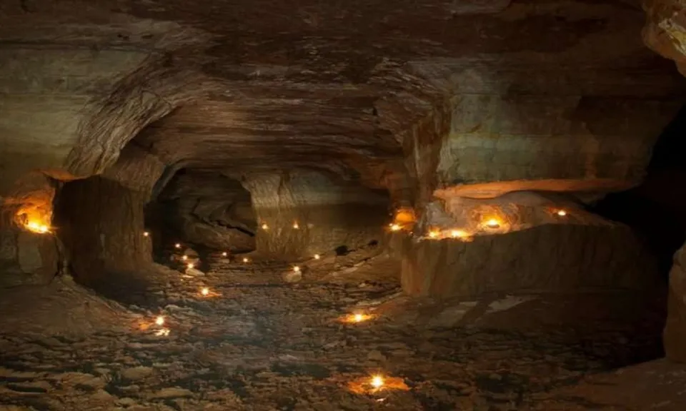 a cave filled with lots of lit candles