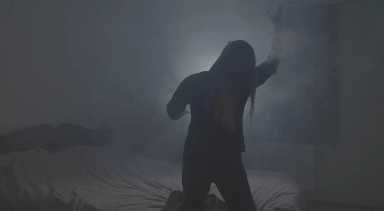 a person standing in a foggy room