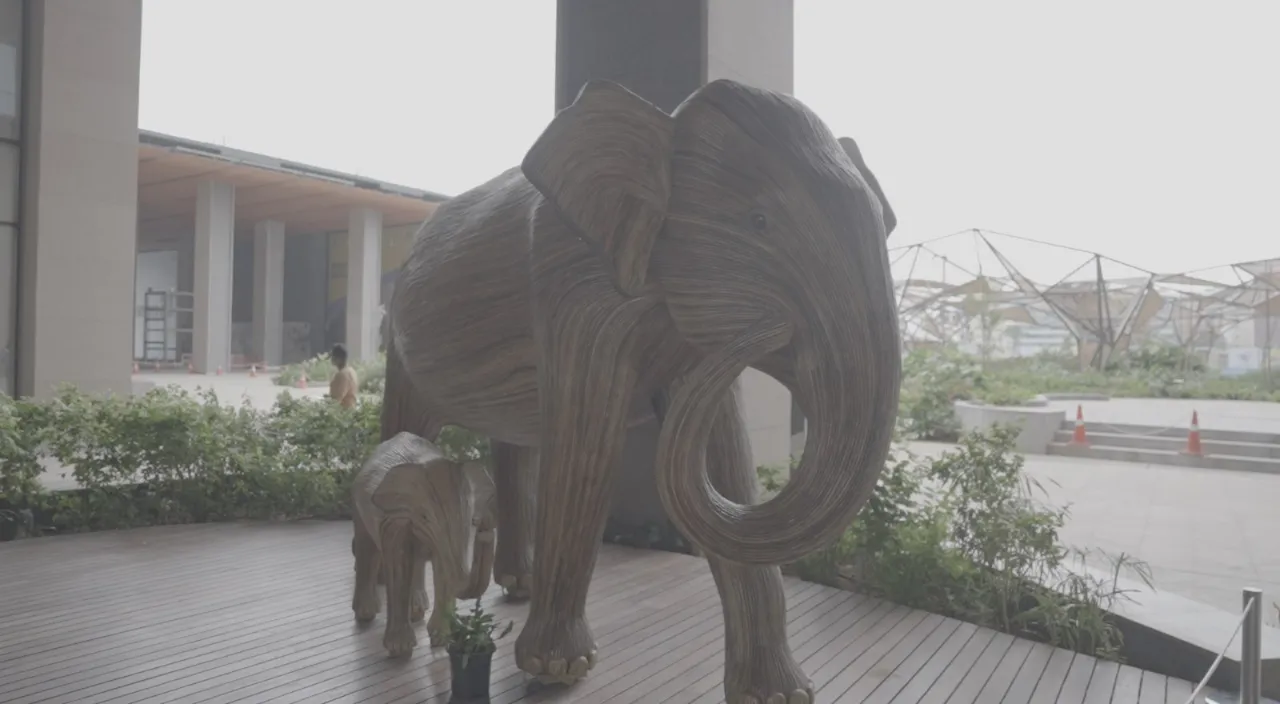 a statue of an elephant and a baby elephant on a deck. 