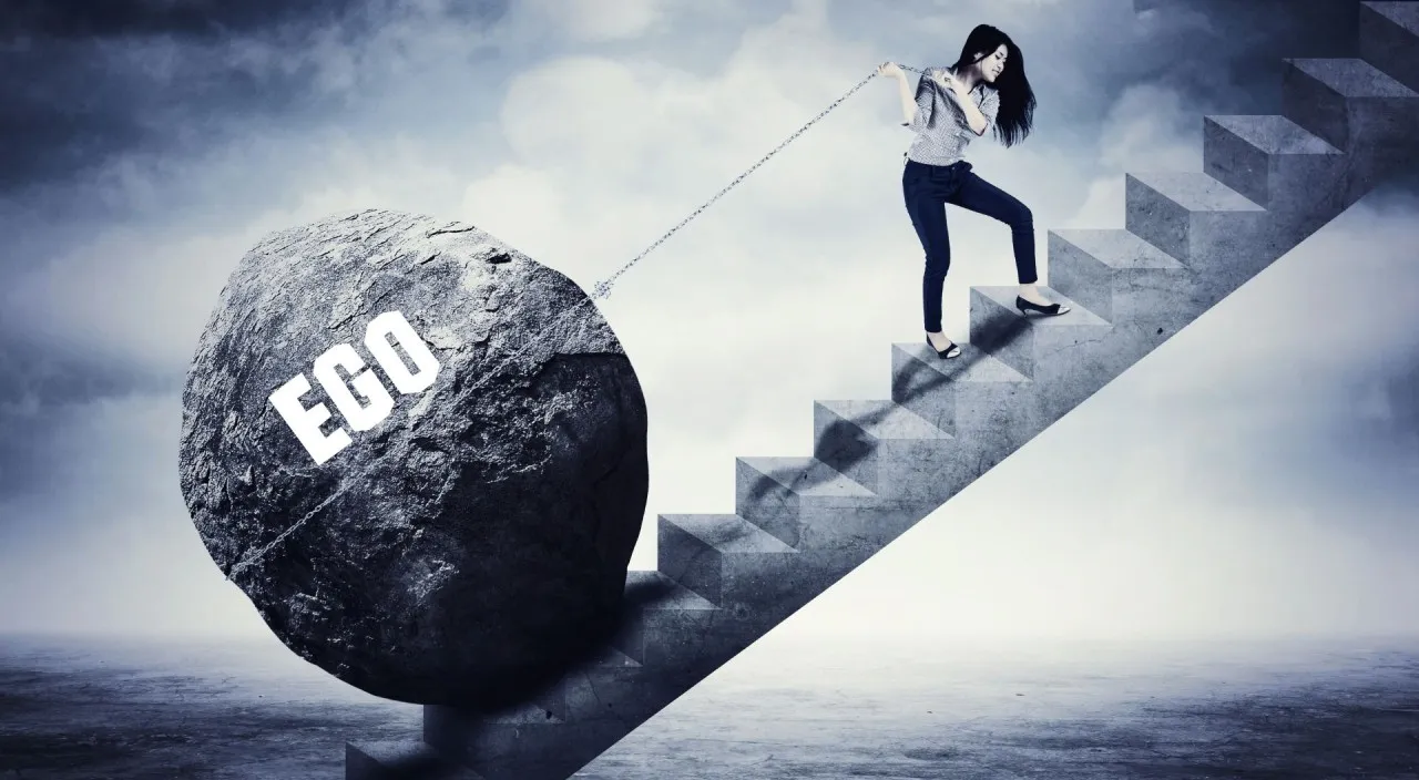 a woman pulling a rock up a stair