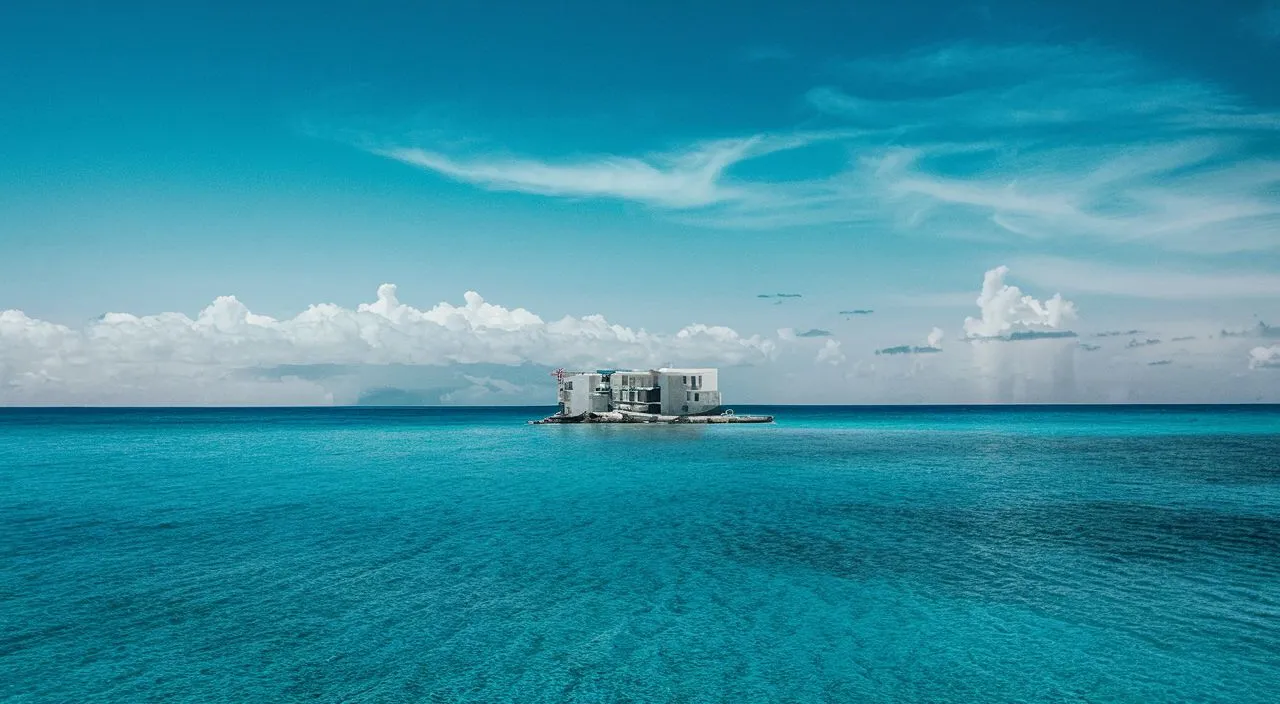 a building on a small island in the middle of the ocean