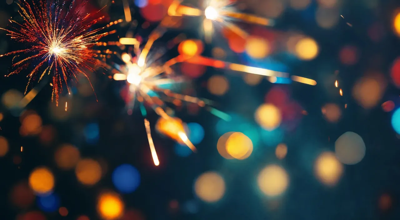 a close up of a fireworks with blurry lights in the background