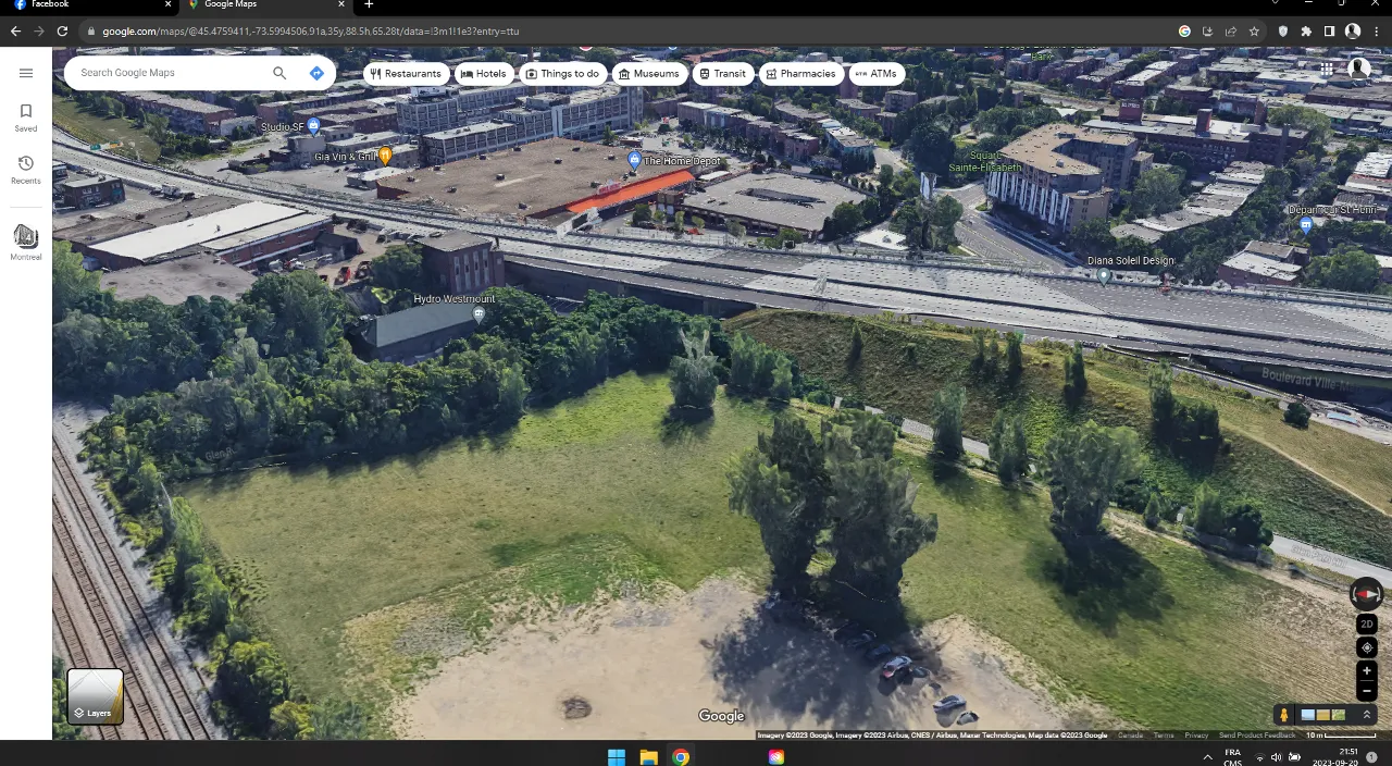 an aerial view of a city with a train track