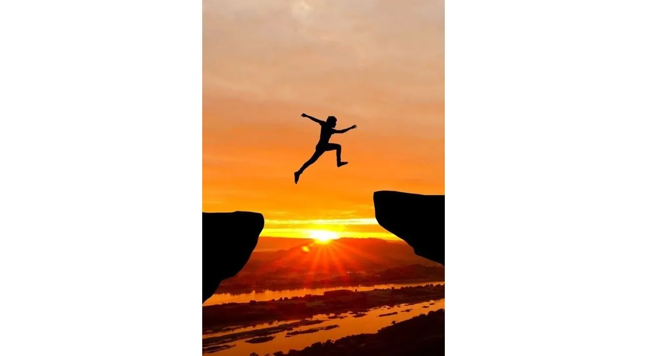 a person jumping off a cliff into the air