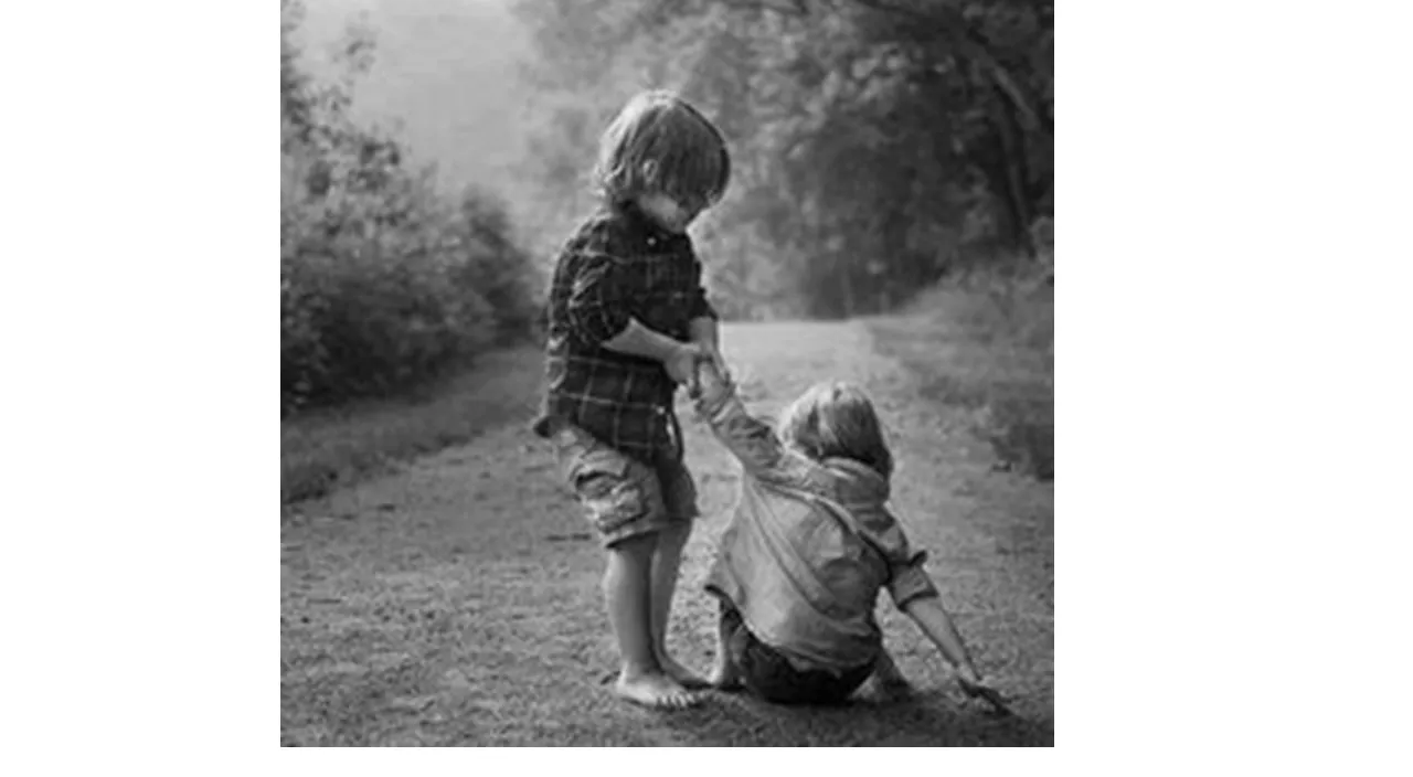 a black and white photo of two children playing