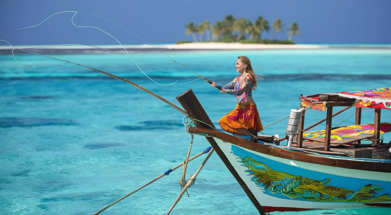 Wide shot of a woman on a traditional fishing boat, casting a line into the water at the Maldive 