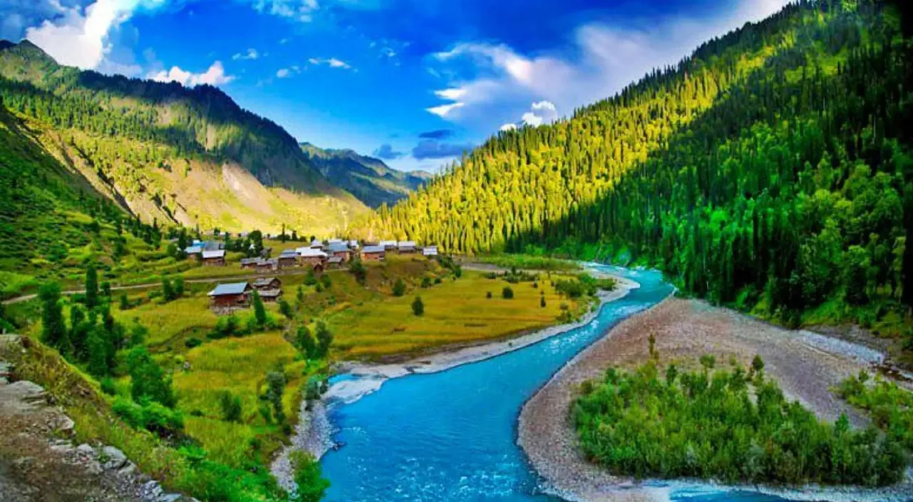 a river running through a lush green valley