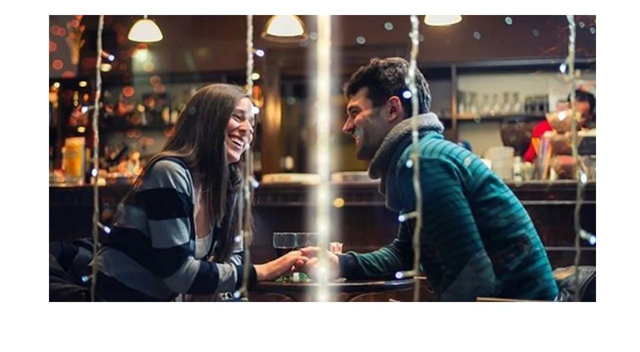 a man and a woman sitting at a bar