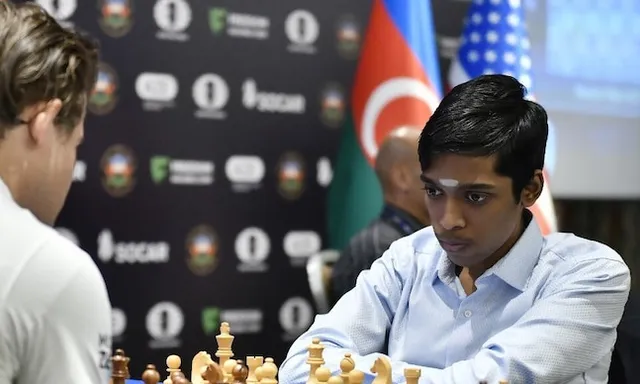 two men sitting at a table playing chess