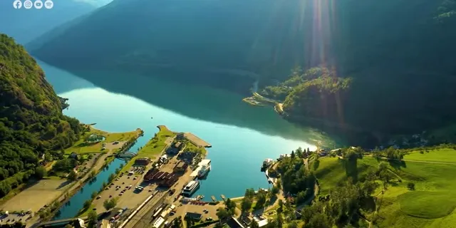 an aerial view of a lake surrounded by mountains