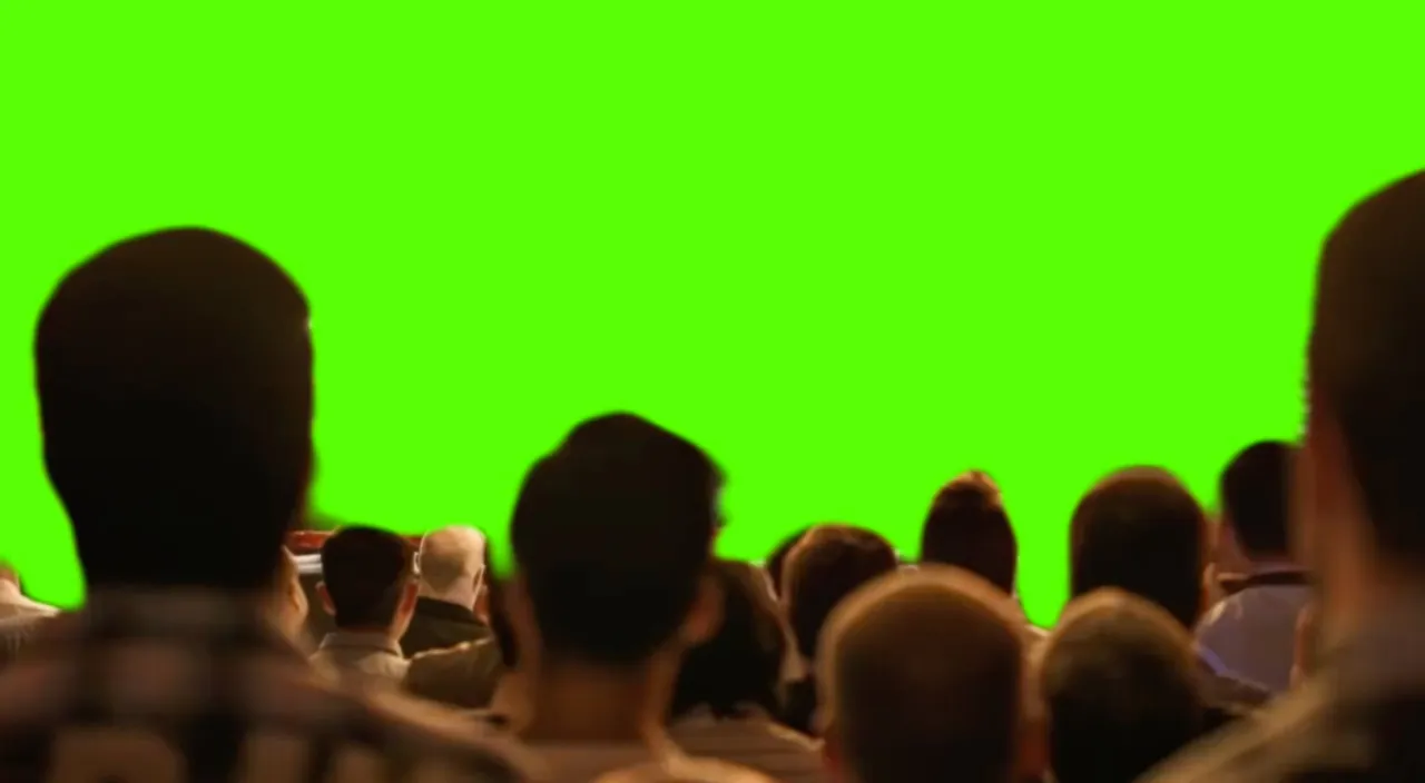 a crowd of people are watching a green screen, cheerful