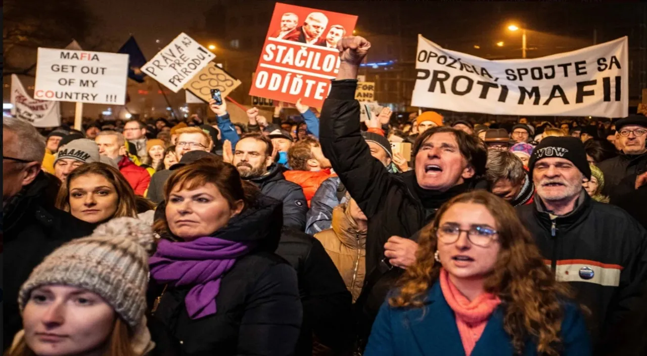 a large group of people holding signs in the air