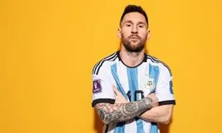 Messi standing in front of a yellow background