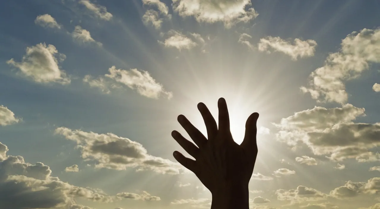 a hand reaching up into the sky with the sun in the background