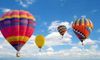 A single-color hot air balloon moving on a blue sky background