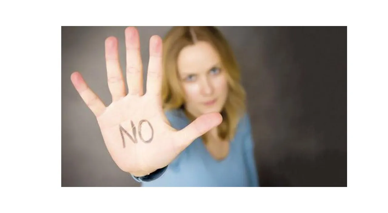 
a woman making a stop sign with her hand