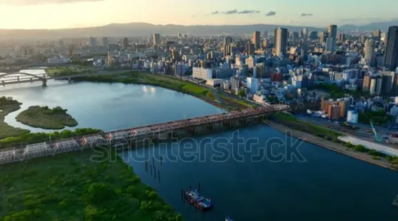 a large body of water surrounded by a city from Osaka Japan