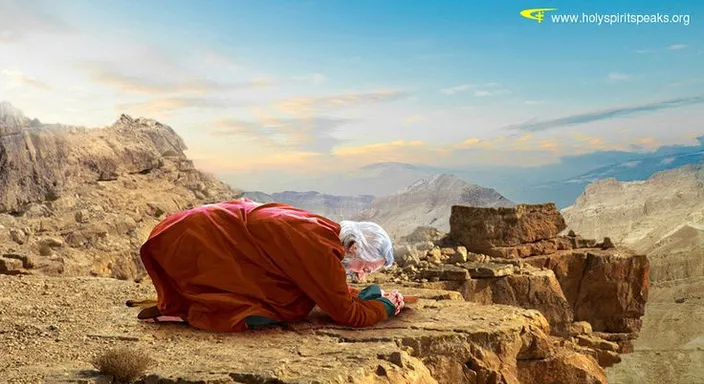 a man sitting on top of a mountain next to a cliff