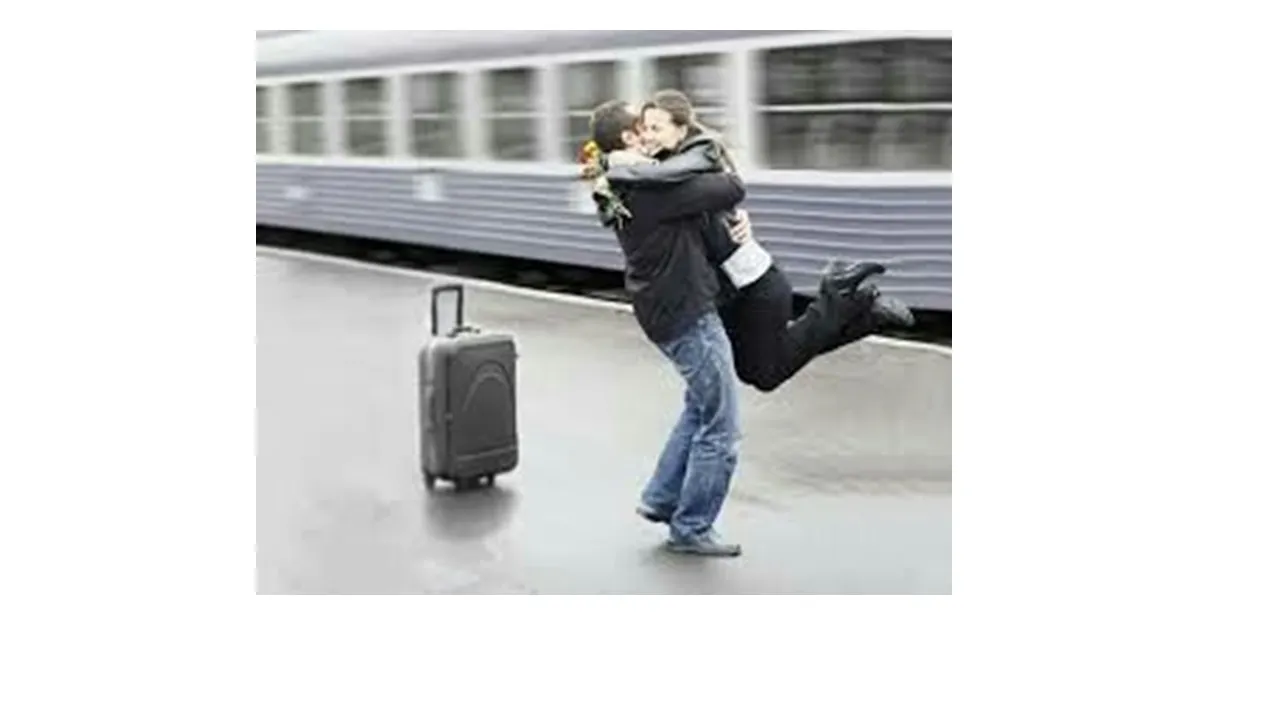 a man carrying a woman on his back in front of a train