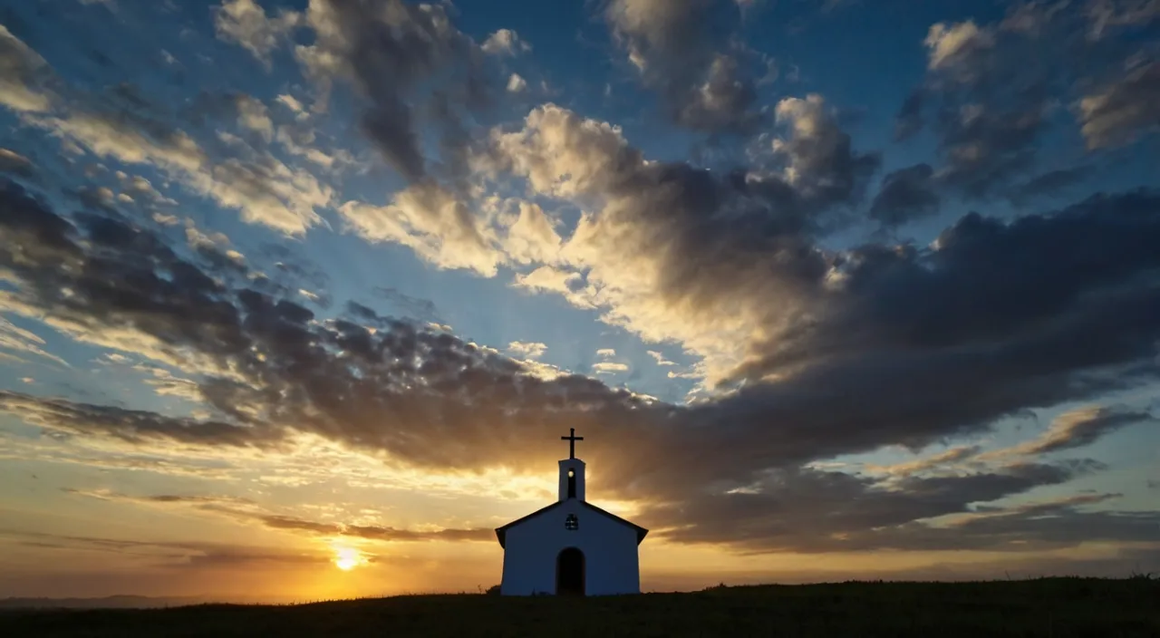 a church on a hill with the sun setting in the background